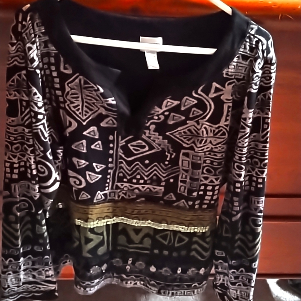 Women's multi colored top with attached accessories on the front.